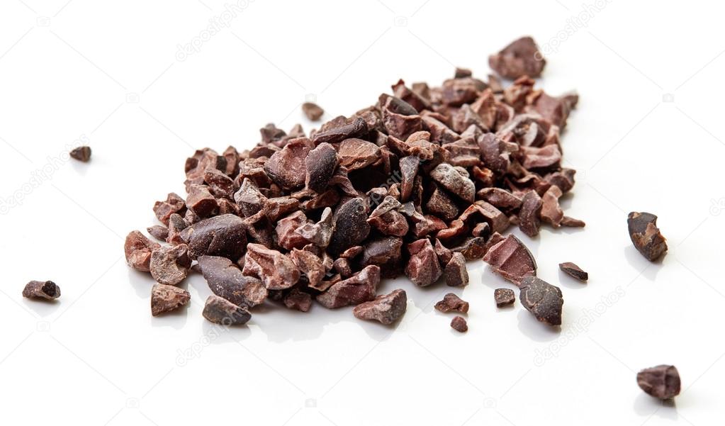 Heap of cacao nibs on white background