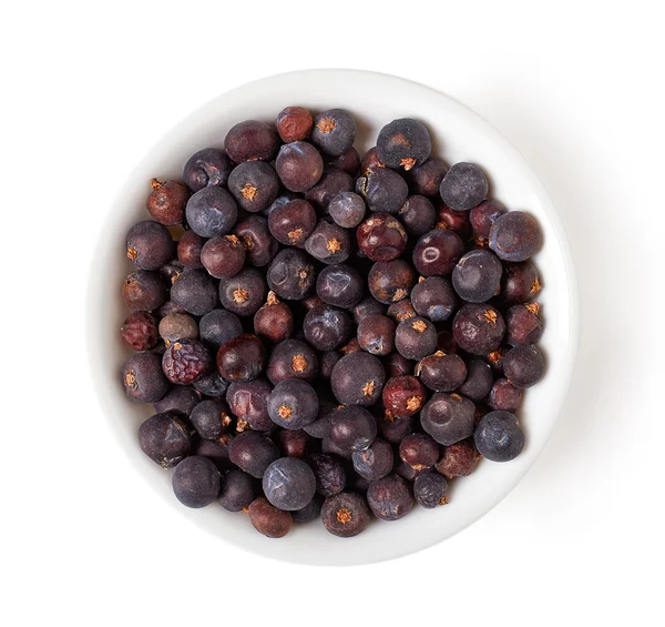 Bowl of juniper berries isolated on white, from above — Stock Photo, Image