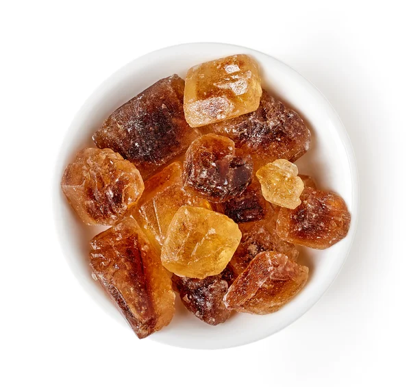 Bowl of caramel sugar crystals isolated on white, from above — Stock Photo, Image