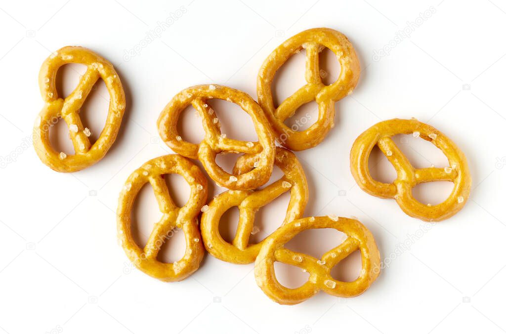 Heap of salted mini pretzels isolated on white background, top view