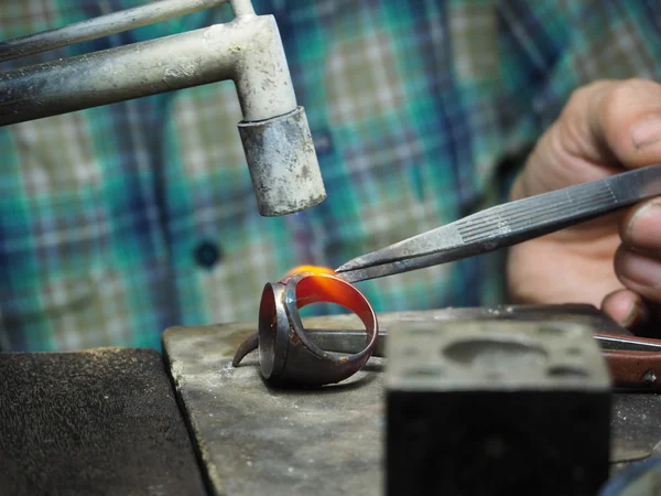 Goldsmith trabajando en un oro inacabado con sus manos trabajadoras — Foto de Stock