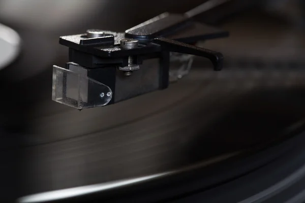 Vinyl player. The rotating disk. Head close-up.
