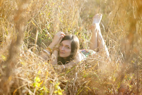 stock image Girl in the grass in the setting sun