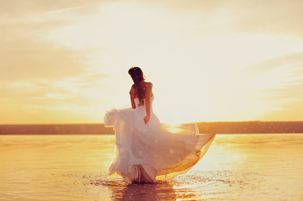 Gorgeous bride standing on the beach