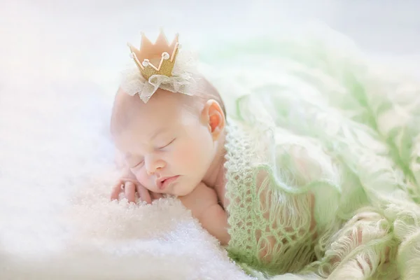 Newborn girl is sleeping like a princess.