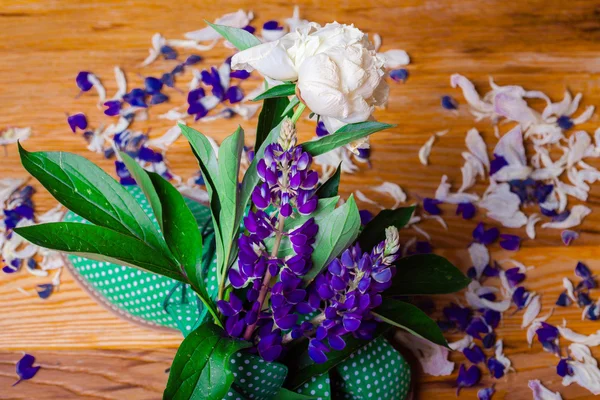 Funny green shoes with flowers in it. wood texture — Stock Photo, Image