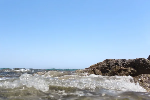 Sea wave stänk över stranden stenar med en hög sea spray — Stockfoto