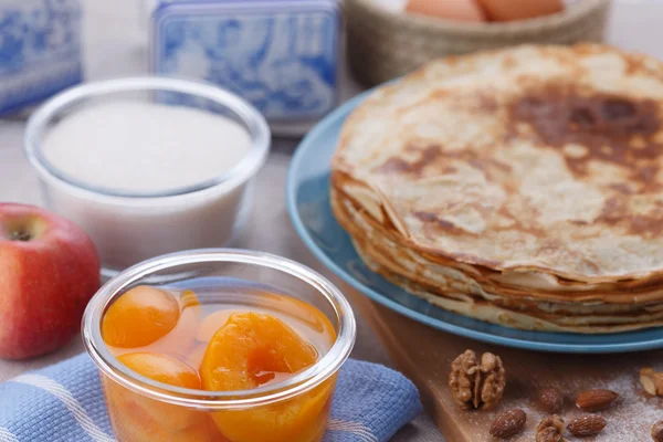 Golden pancakes in a blue plate — Stock Photo, Image