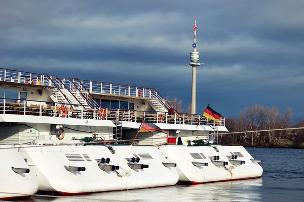 Sterns of ferries on the bank of Danube river in Vienna, Austria