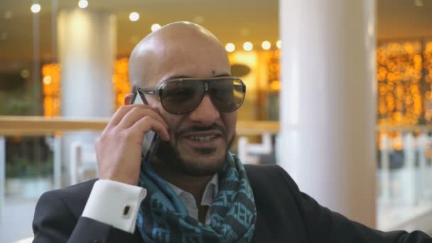 Arab businessman talking on mobile phone in hotel — Stock Video