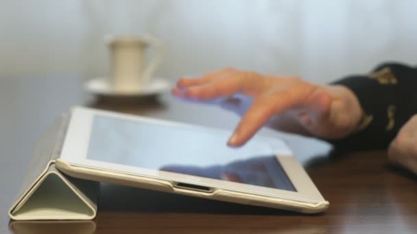 Woman looking at pictures on digital tablet — Stock Video