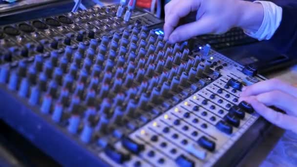 DJ works on the mixer at a nightclub — Stock Video