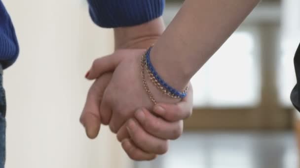 Хлопчик і дівчинка тримаються за руки з любов'ю — стокове відео