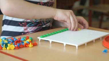 Küçük çocuk bir entelektüel bir masada oynuyor