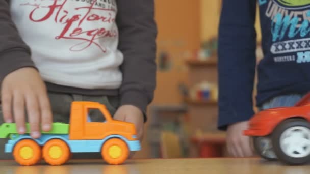 Les enfants jouent jouets modèles de voitures à la table — Video