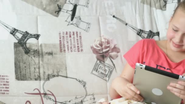 Barn läser en digital tablet ligger på sängen — Stockvideo
