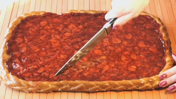 Cutting of a strawberry pie using a steel knife — Stock Video