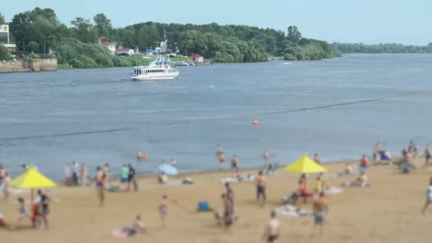 People swimming and sunbathing on the sand beach — Stock Video