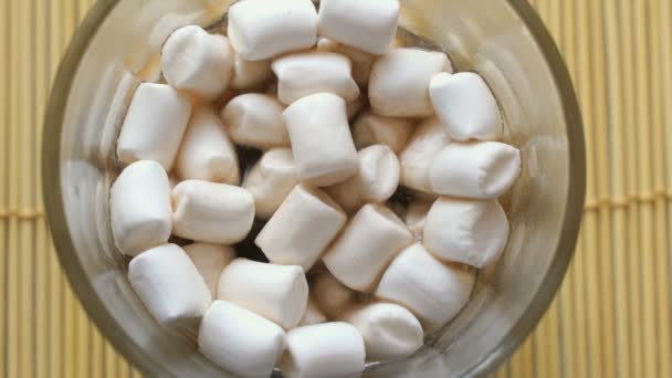 Fluffy white marshmallows in the glass cup — Stock Video