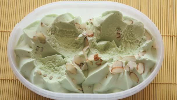 People take the pistachio ice cream of a container — Stock Video