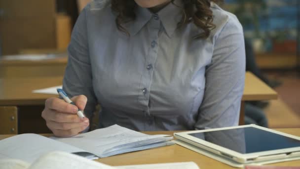 Joven alumno escribe en un cuaderno en el aula — Vídeos de Stock