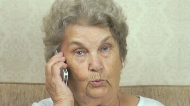 Yaşlı kadın kanepede oturan smartphone söz