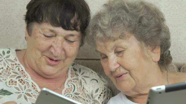 Two elderly grandmothers holding digital tablets — Stock Video