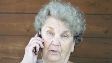 Yaşlı kadın cep telefonda konuşurken
