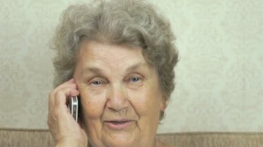 Kadın elinde tutan bir cep telefonu