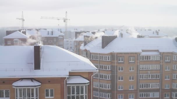 El humo de las chimeneas de una casa residencial de cinco pisos en invierno — Vídeo de stock