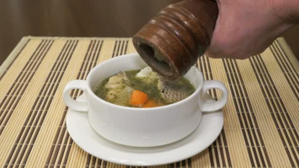 Black pepper is added to the Macrourus fish soup — Stock Footage Black pepper is added to the Macrourus fish soup Royalty Free Stock Footage