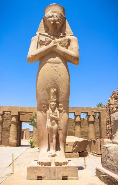 Statue of Ramses II with his daughter Merit-Amon in the temple of Amun-RA (the temple of Karnak in Luxor) clipart