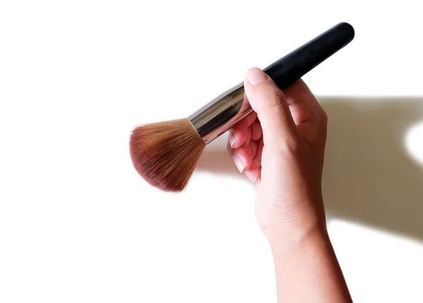 Hand holding makeup brush and powder background — Stock Photo, Image