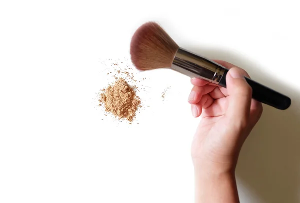 Hand holding makeup brush and powder background — Stock Photo, Image
