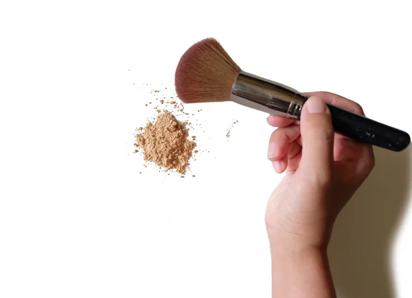 Hand holding makeup brush and powder background — Stock Photo, Image