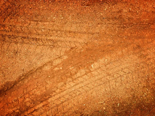 Pistas de neumáticos en el camino grava piedra fondo —  Fotos de Stock