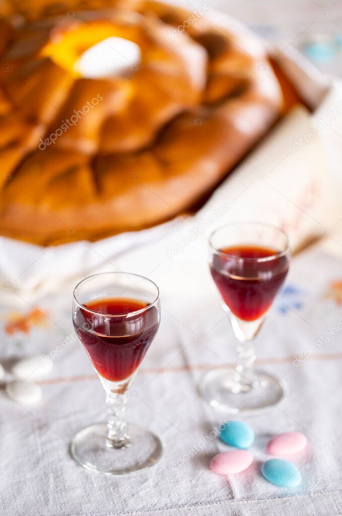 A glass of port wine with sponge cake during Easter celebration, a tradition to receive Jesus in our home, Braga, Portugal.