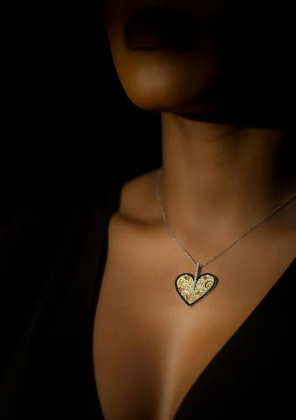 Fashion handmade Jewelry in a beautiful African Girl neck, on a black background.