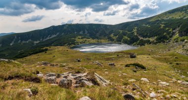 Romanya 'nın Retezat dağlarının etrafındaki tepeler çoğunlukla çimen ve inus mugo çalılarıyla kaplı Zanoaga Mare Gölü