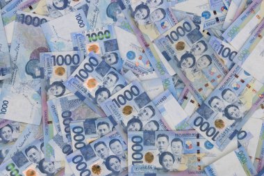Binlerce Filipinli banknot yığını. Bin dolarlık banknotlar, peso arkaplan resmi..