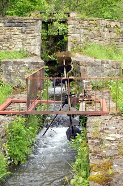Wheel with iron water pulling an electric generator.