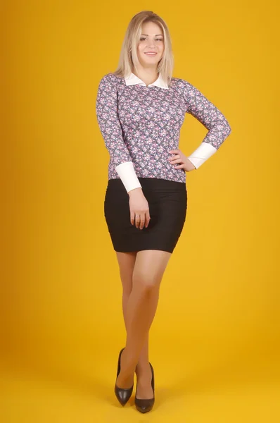 Beautiful young girl  posing on a yellow background — Stock Photo, Image