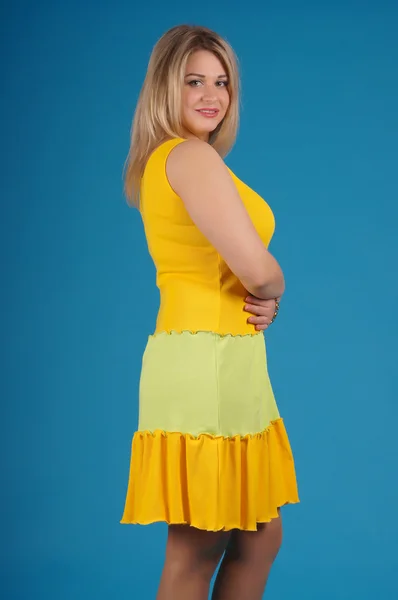 Beautiful young girl  posing on a yellow background — Stock Photo, Image