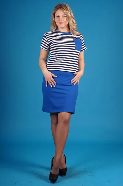 Beautiful young girl  posing on a blue background Stock Photo