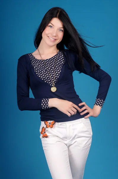 Beautiful young girl  posing on a blue background — Stock Photo, Image