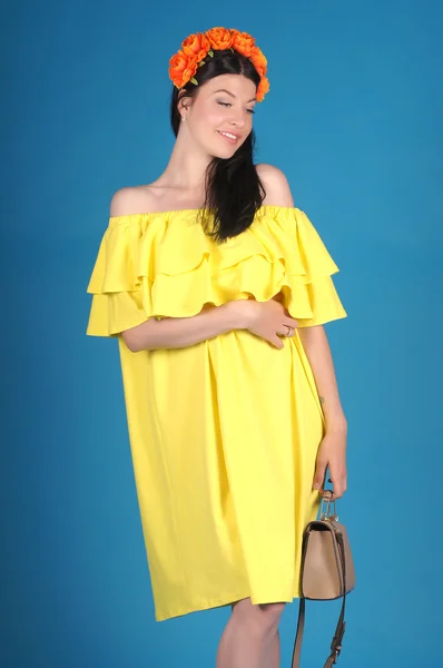 Beautiful young girl  posing on a blue background — Stock Photo, Image