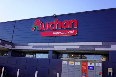 MARINGUES, FRANCE - 18 Mart 2026 Auchan süpermarket cephesi ve paket teslimat dolapları.