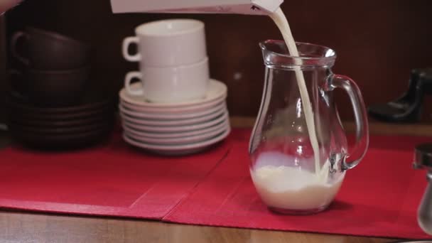 Barista pouring milk into a glass jug. Medium shot — Stock Video