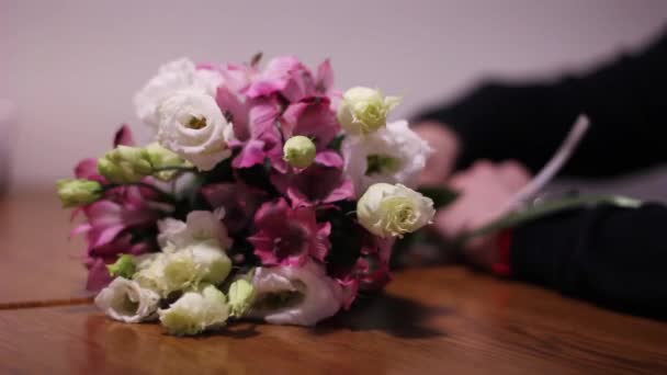 Bouquet of beautiful flowers on the table — Stock Video