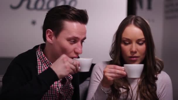 Couple in the coffee shop taste cappuccino and easy communicate. — Stock Video